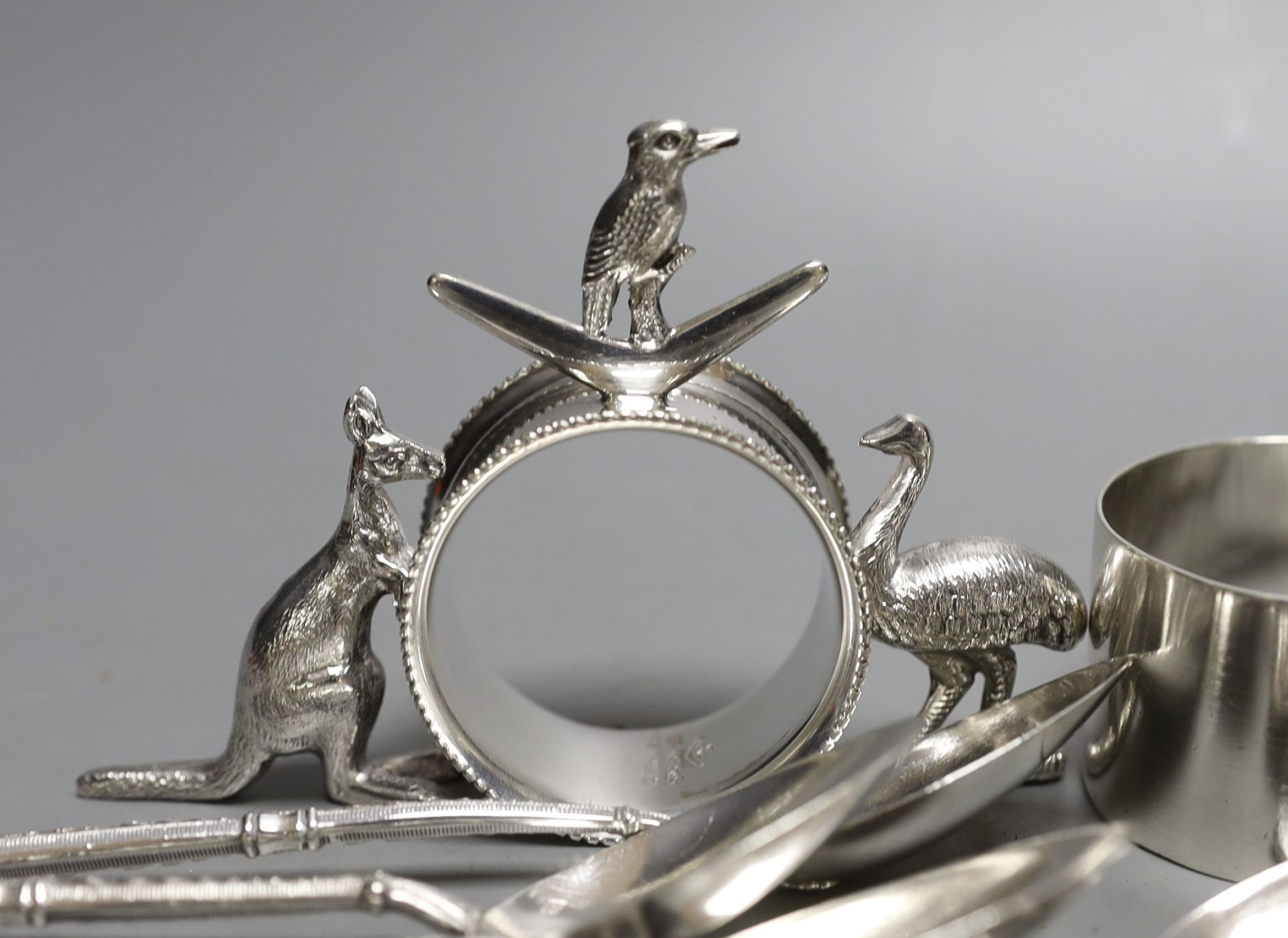 A set of six late Victorian silver coffee spoons, Sheffield, 1884, a set of six early 20th century French white metal teaspoons, two silver napkin rings and an Australian E.P.N.S. napkin ring.